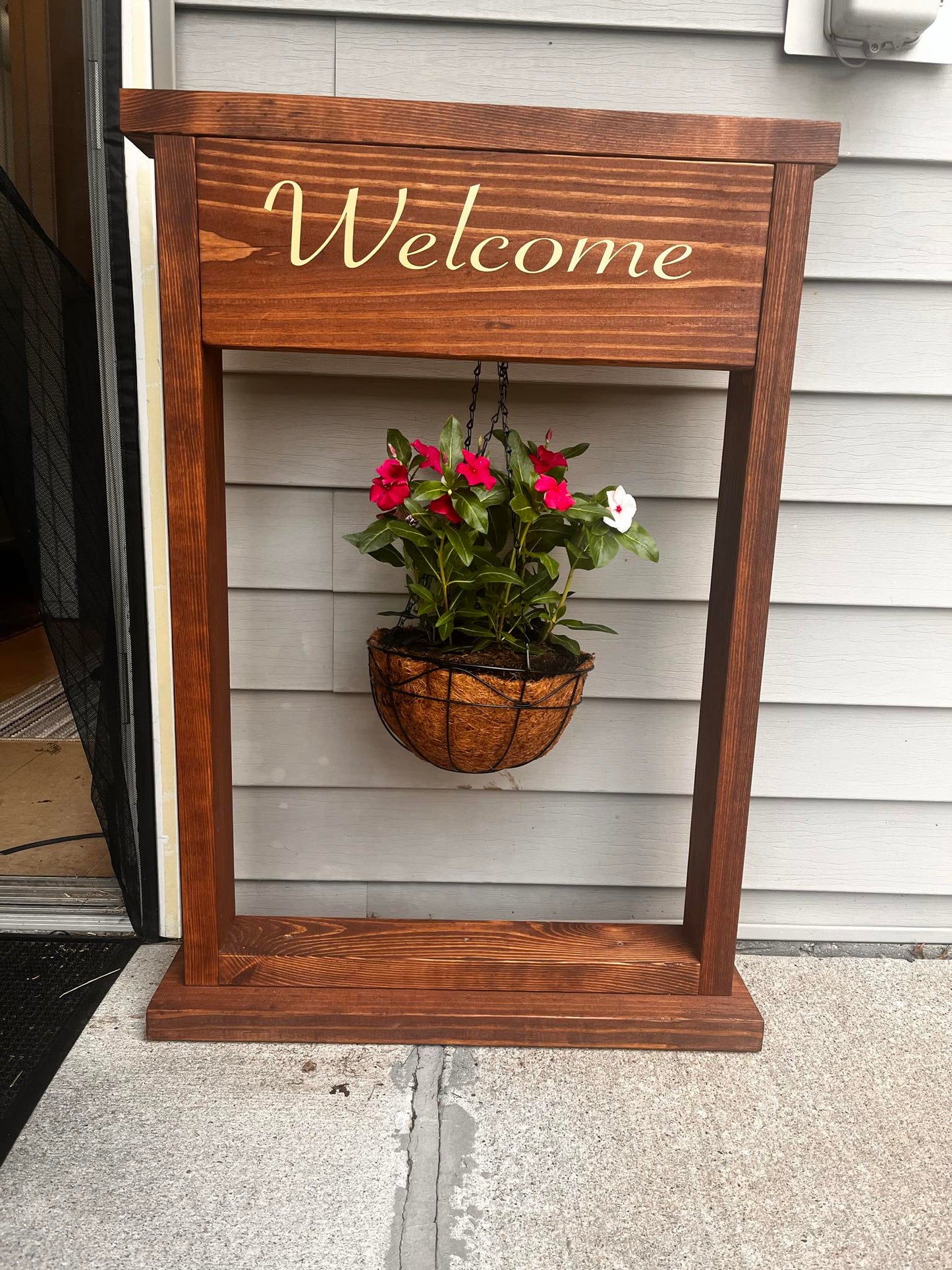Welcome sign and hanging plant