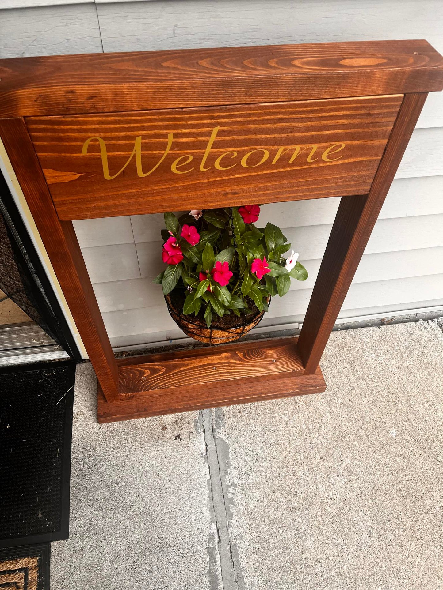 Welcome sign and hanging plant