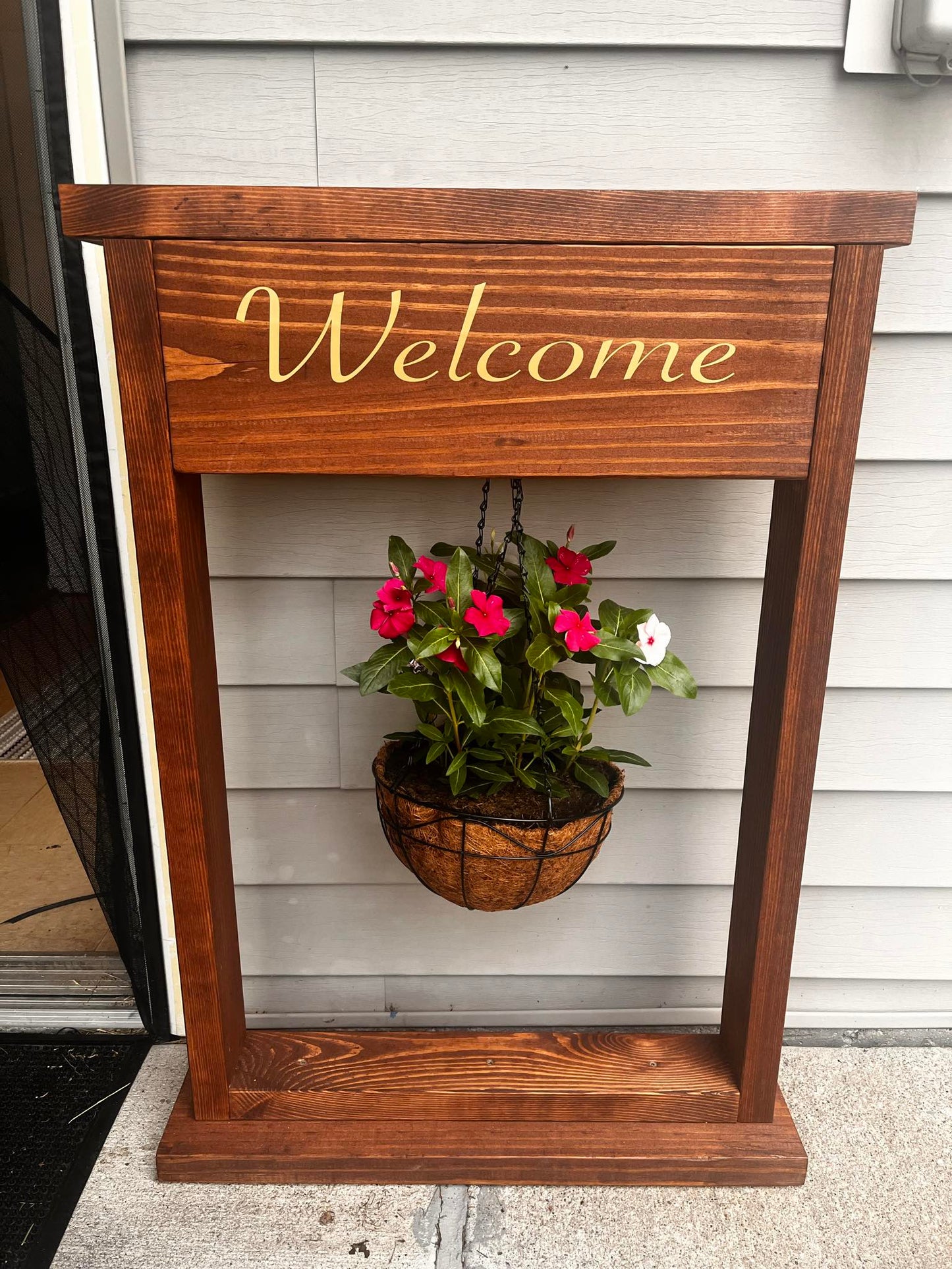 Welcome sign and hanging plant